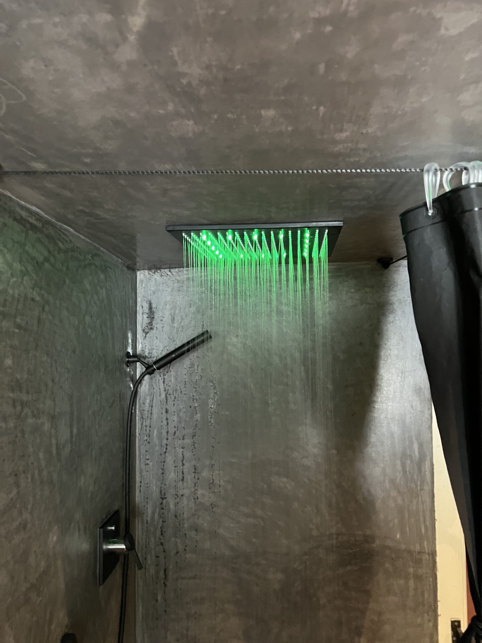 Green-themed shower in The Loft apartment, Arbaz