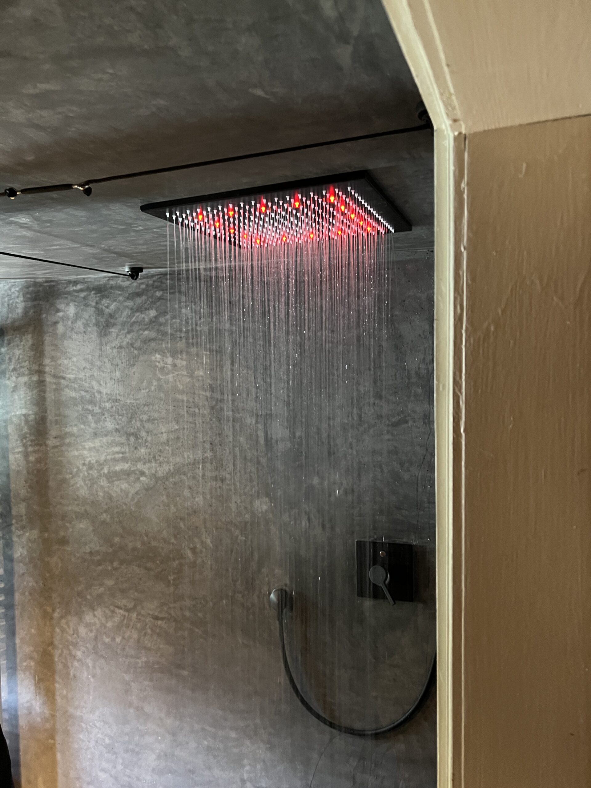 Red-themed shower in The Loft apartment, Arbaz
